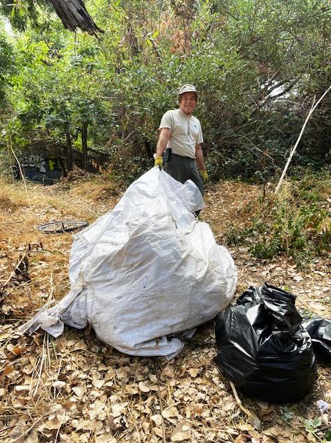 Charles with the big bag of trash.